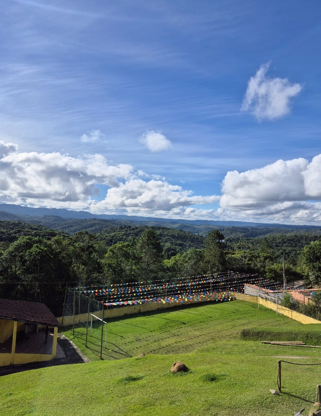 Campo de futebol gramado com vista para a serra